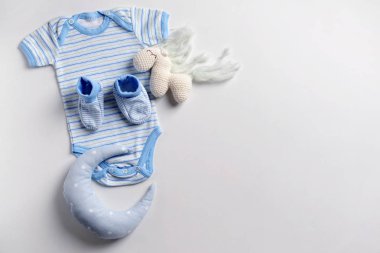 Sevimli bebek giysileri ve beyaz arka plan üzerinde oyuncaklar