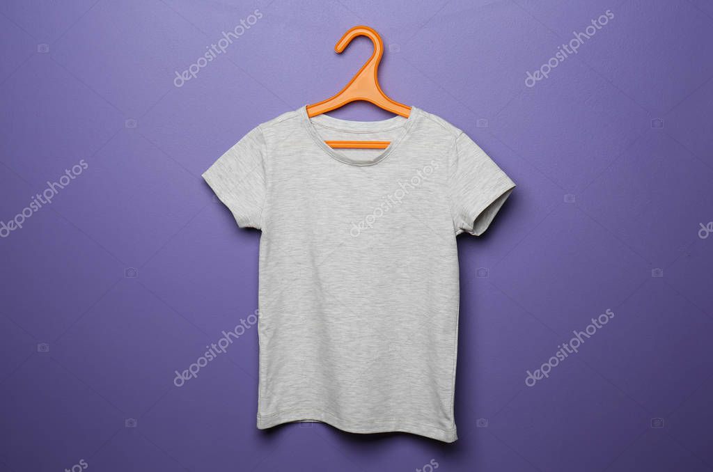 Child t-shirt with hanger on color background