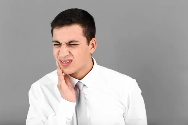 Young Man Suffering Toothache Grey Background — Stock Photo, Image