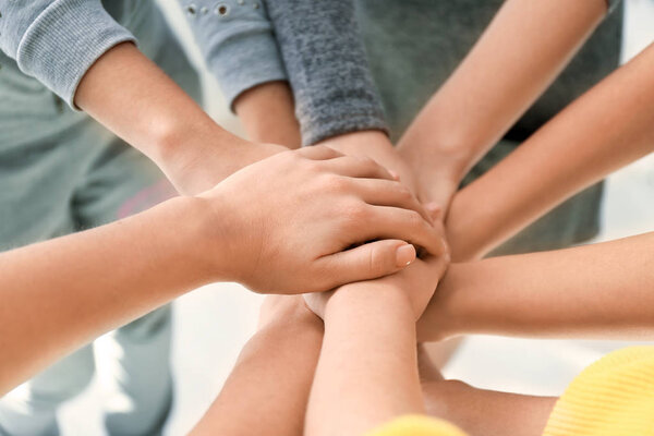 People putting hands together, closeup. Unity concept