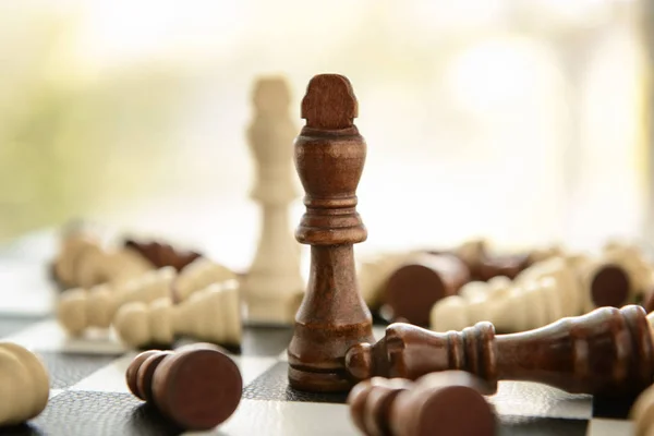 Game board with chess pieces on blurred background