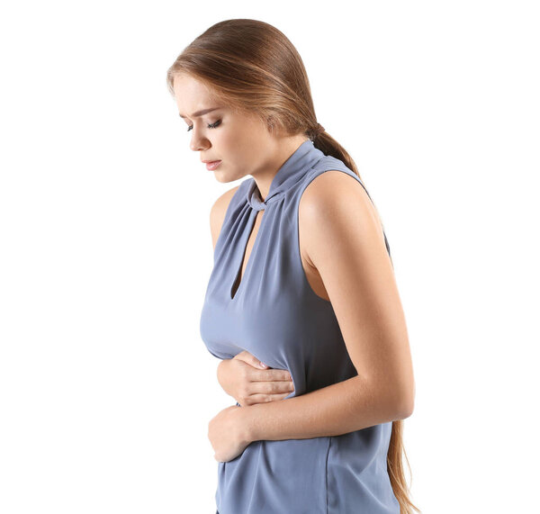 Young woman suffering from abdominal pain on white background