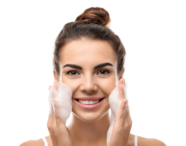 Beautiful young woman with soap foam on white background