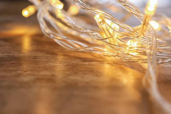 Glowing Christmas Lights Table Closeup — Stock Photo, Image