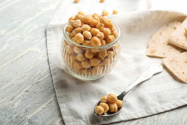 Glass jar with chickpeas on light table