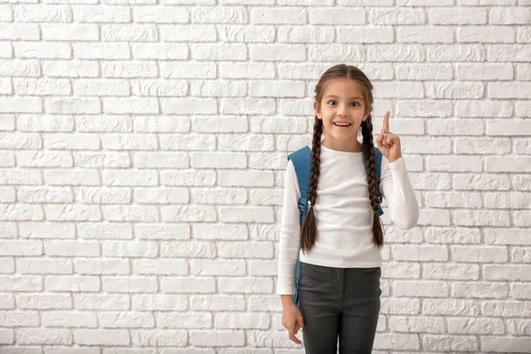 Cute Girl Backpack Raised Finger White Brick Background — Stock Photo, Image