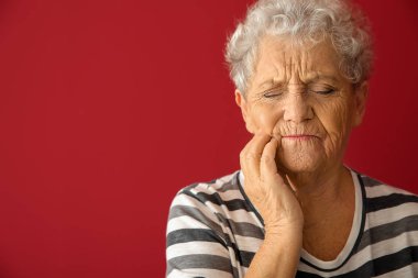 Arka planda diş ağrısı çeken son sınıf öğrencisi bir kadın.