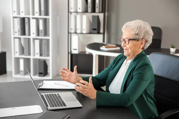 Elderly woman after making mistake during work with laptop