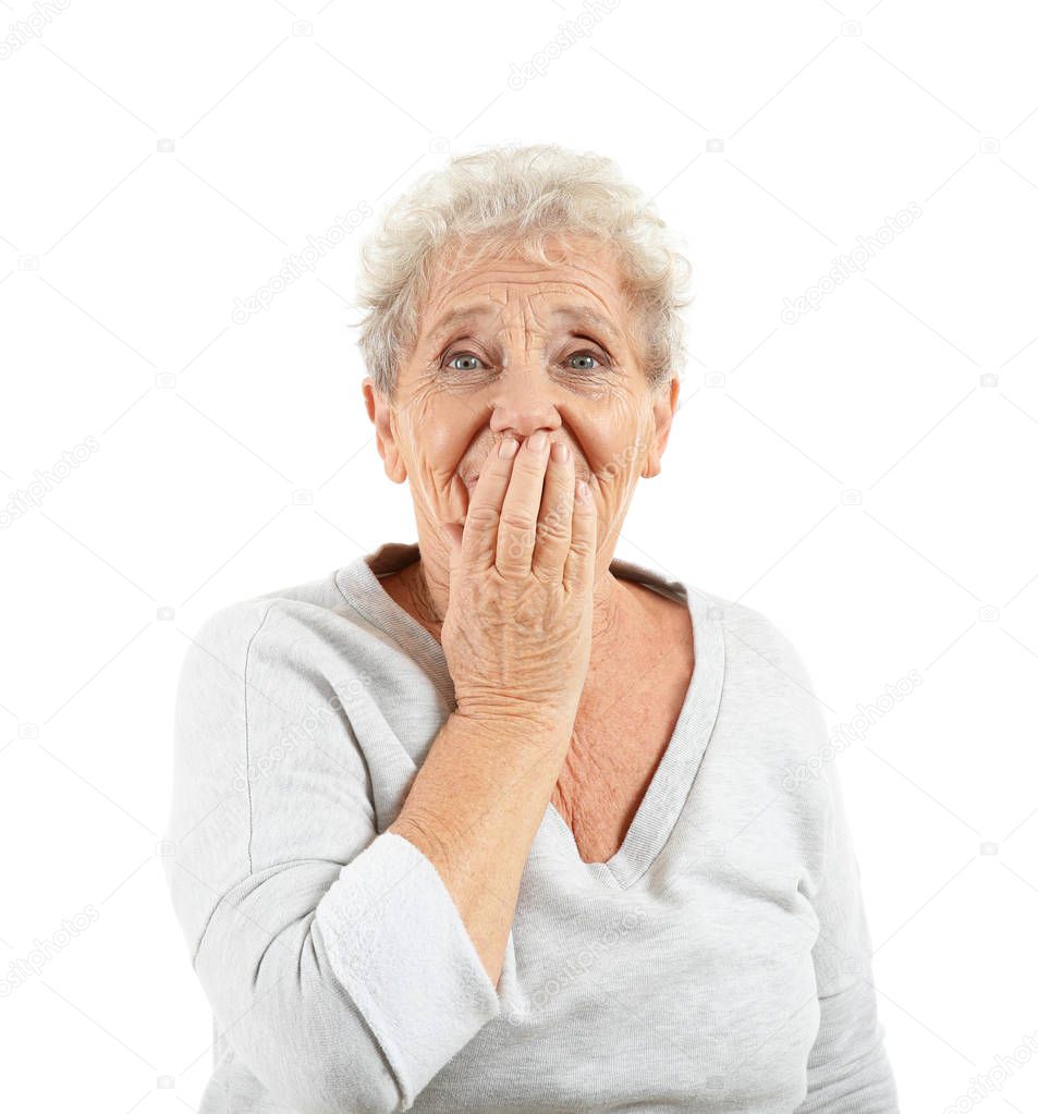 Portrait of elderly woman after making mistake on white background