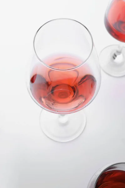 Glass of tasty wine on white background