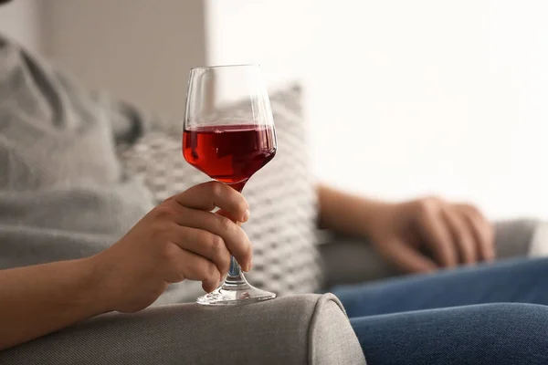 Man with glass of wine relaxing at home