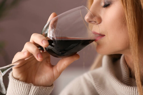 Beautiful woman with glass of wine, closeup