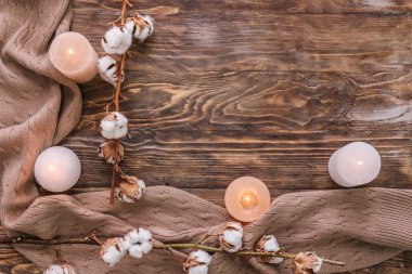 Mumlar, pamuk çiçek ve ahşap zemin üzerine sıcak ekose