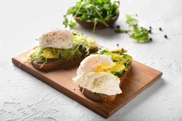 Tasty Toasts Avocado Eggs Benedict Wooden Board — Stock Photo, Image