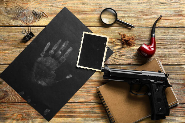 Composition with different items for detective on wooden table