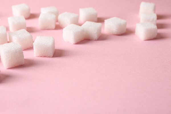 Refined sugar cubes on color background