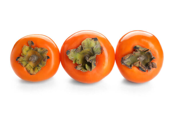 Ripe persimmons on white background