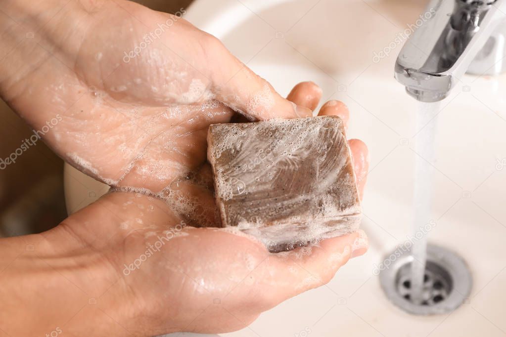 Man washing hands with soap, closeup