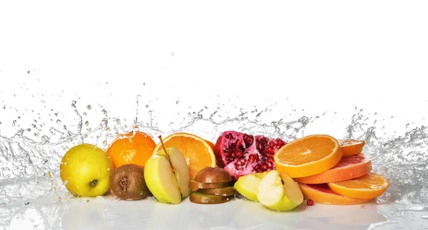 Fresh fruits with splashing water on white background