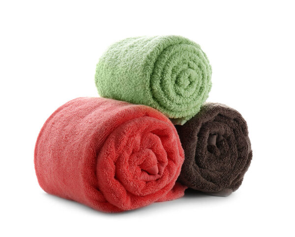 Rolled clean soft towels on white background
