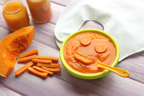 Mutfak masasının üzerinde sağlıklı bebek maması ile kase