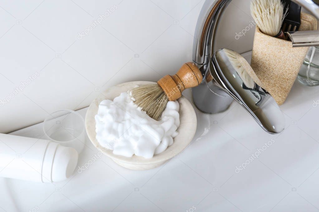 Shaving accessories with cosmetics for men on sink in bathroom