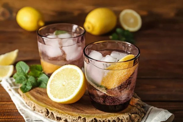Glasses of fresh lemonade on wooden stand