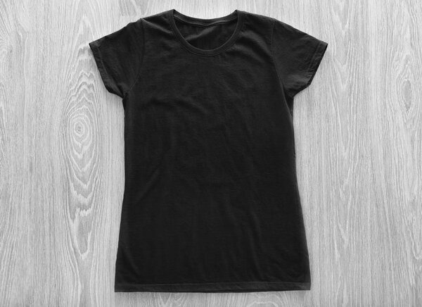 Blank black t-shirt on wooden background
