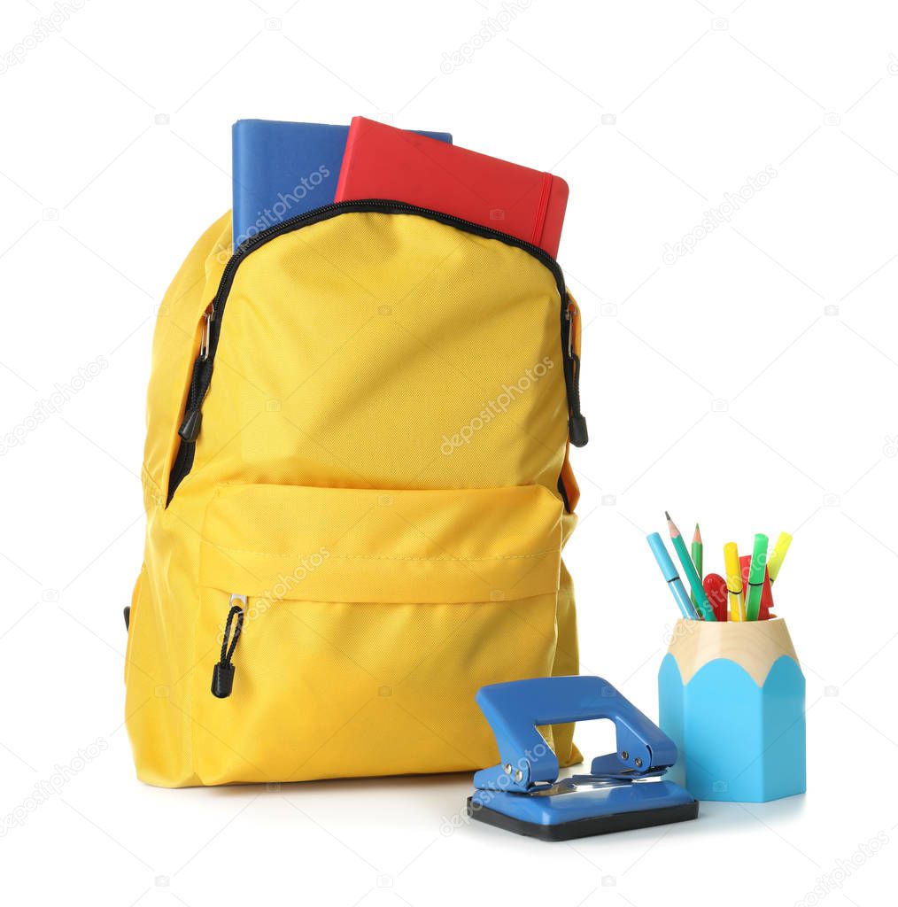 Backpack with school supplies on white background