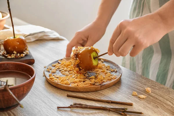 Woman Rolling Caramel Apple Cornflakes Wooden Table — Stock Photo, Image