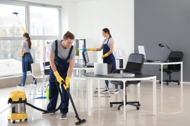Team of janitors cleaning office clipart