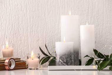 Beyaz duvar yakınındaki masada mumlar yanan ile güzel kompozisyon