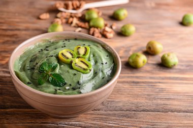 Ahşap masa üzerinde lezzetli spirulina güler yüzlü ile kase