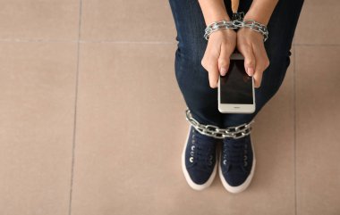 Kadın zincirleme elleriniz ve cep telefonu kapalı. Bağımlılık kavramı