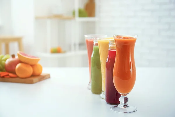 Glassware of tasty smoothies on light table
