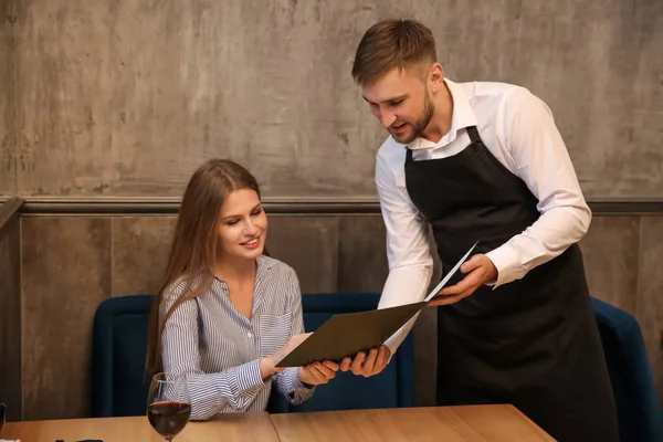 Young Waiter Showing Woman Menu Restaurant — Stock Photo, Image