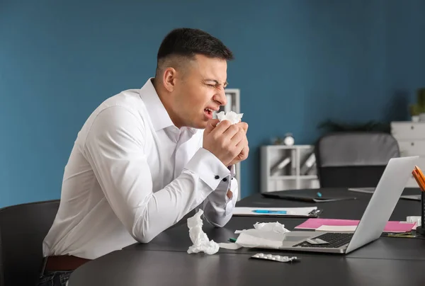 Young man ill with flu in office