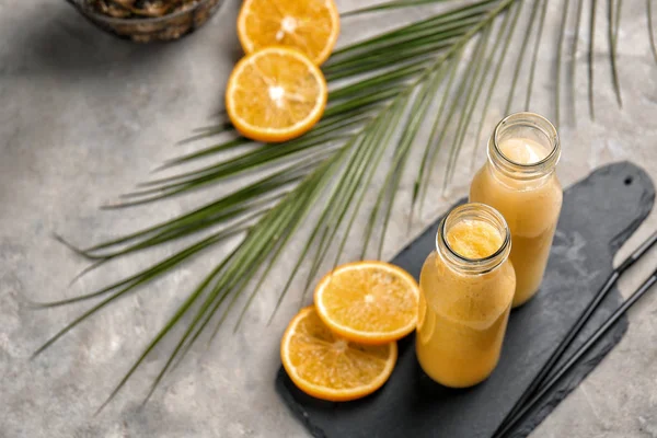 Bottles Tasty Yellow Smoothie Fruits Tropical Leaf Grey Table — Stock Photo, Image