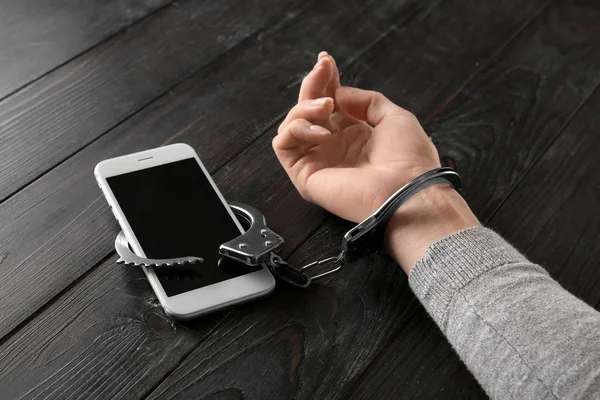 Female Hand Handcuffs Mobile Phone Wooden Background Concept Addiction — Stock Photo, Image