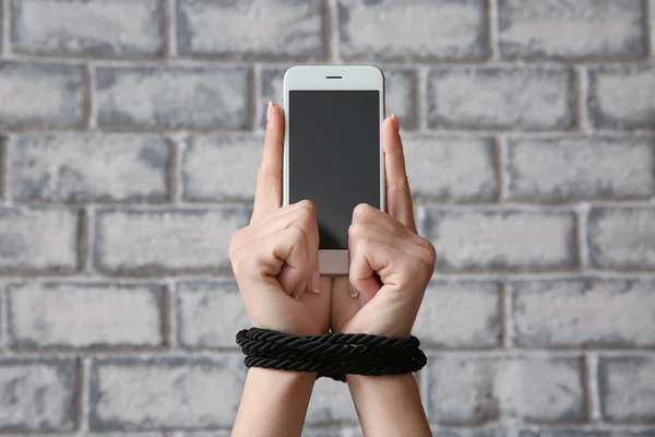 Woman Tied Hands Mobile Phone Brick Wall Background Concept Addiction — Stock Photo, Image