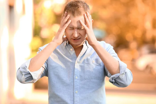 Man having panic attack outdoors