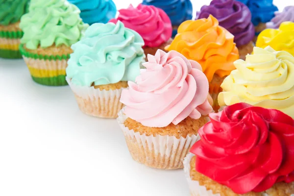 Delicious colorful cupcakes on white background