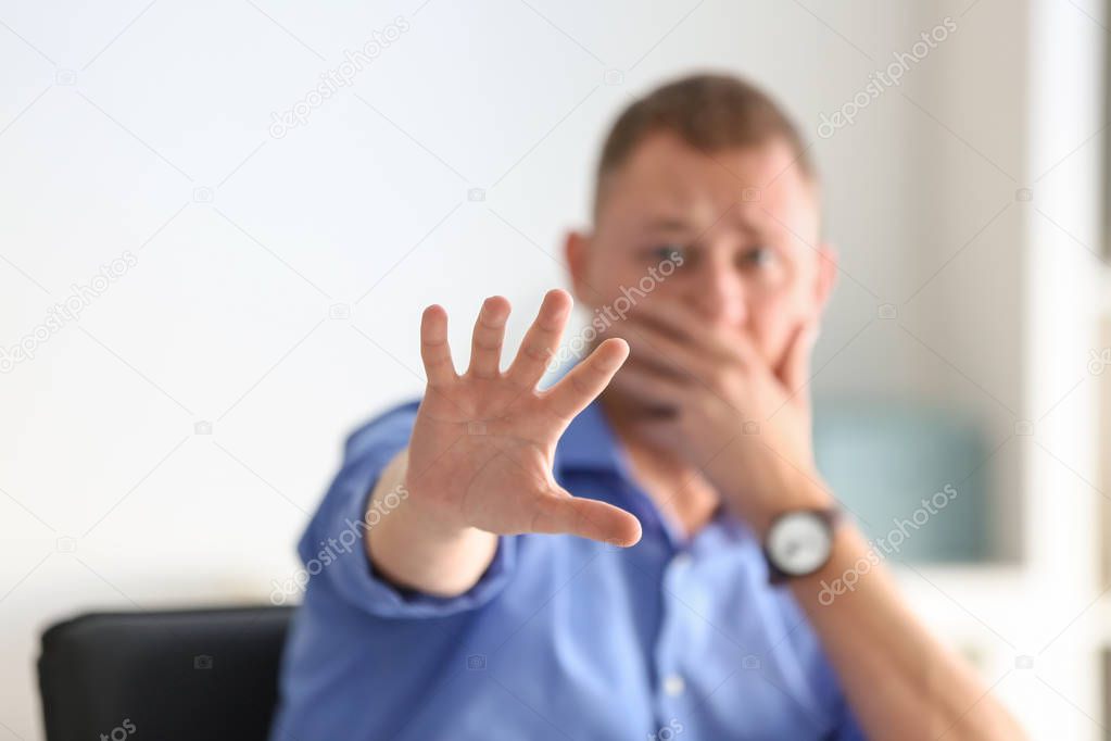 Man having panic attack at workplace in office