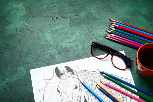 Anti-stress coloring picture and pencils on table