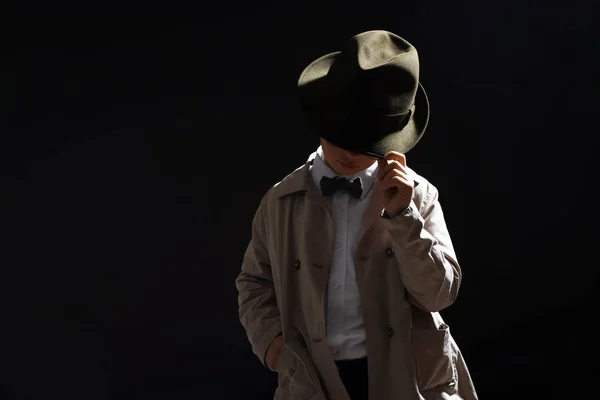 Cute little detective on dark background