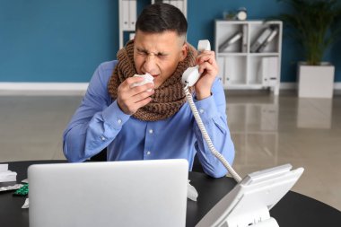 Genç adam ofisinde grip olmuş.