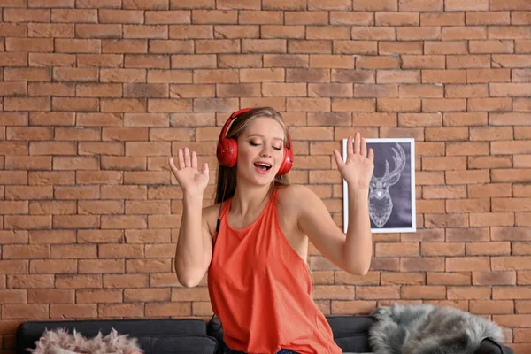 Beautiful young woman dancing at home