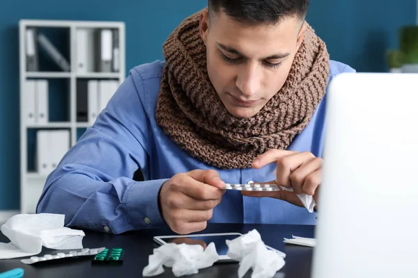 Young man ill with flu in office