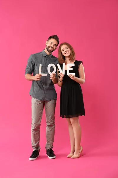 Loving Young Couple Holding Word Love Color Background Celebration Saint — Stock Photo, Image