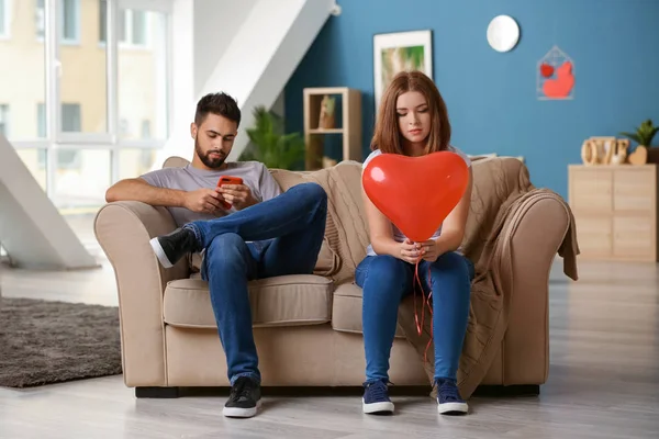 Sad Young Woman Holding Heart Shaped Balloon Indifferent Man Playing — Stock Photo, Image